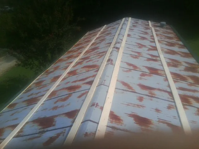 Rusted metal roof panels with new wood purlins before replacement — Storm Damage Roof Repair in Bethany by Roofing Brothers